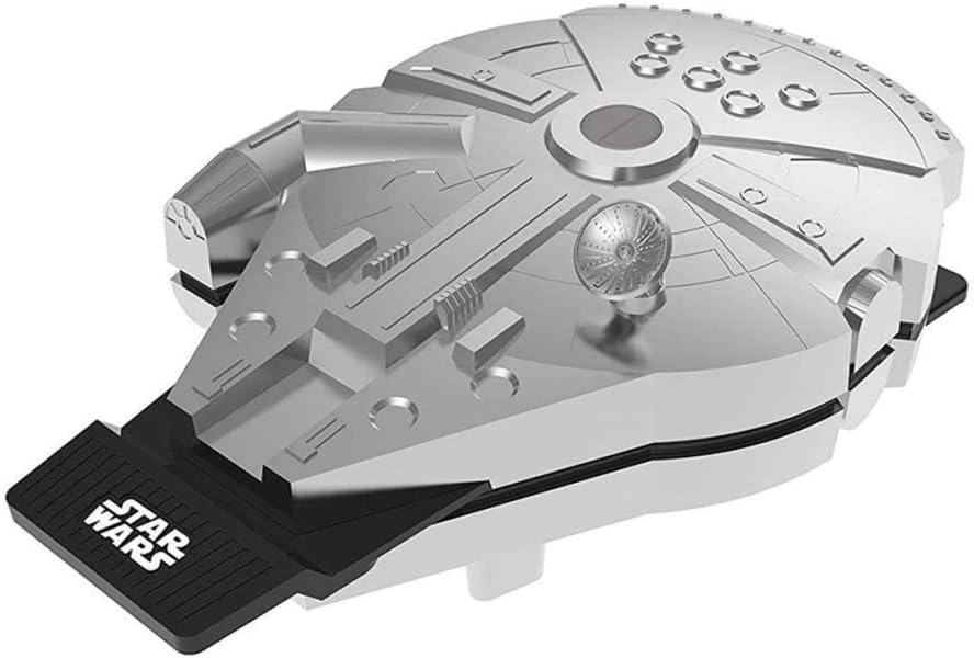 A silver and black waffle iron shaped like the iconic Millennium Falcon spaceship from Star Wars, featuring detailed sculpted panels and a black base with "STAR WARS" branding.