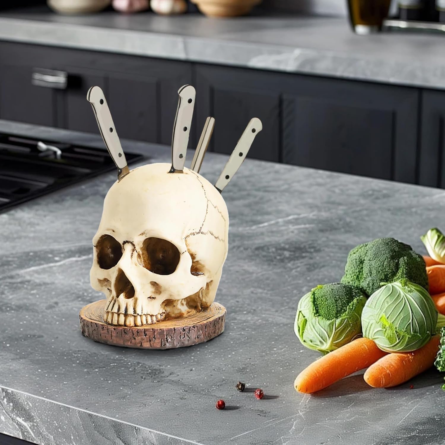 A decorative skull-shaped knife block with a wood base holds five kitchen knives with cream-colored handles, displayed on a gray countertop alongside fresh vegetables including broccoli and carrots.